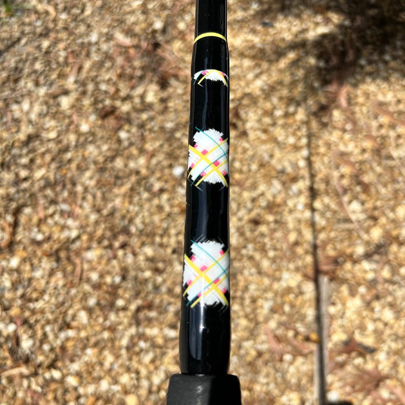 Load image into Gallery viewer, Built like our Fin #18, this spinning rod comes with Fuji alconite guides, EVA foam grips, Fuji reel seat, and metal gimble. Butt Wrap showing. All black blank with yellow trim. &quot;egg shaped&quot; wrap with teal, white, pink and yellow. 
