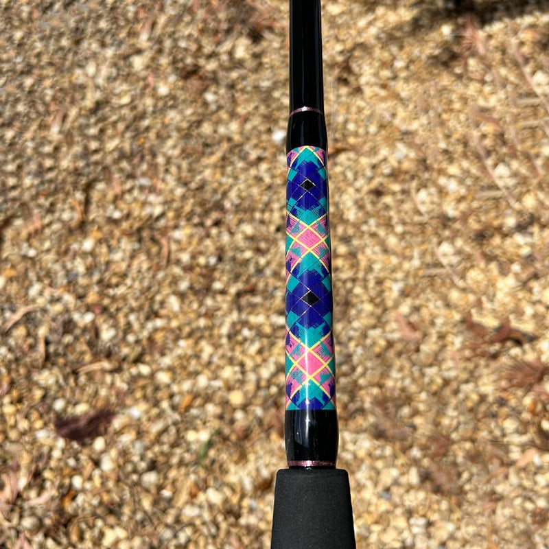 Load image into Gallery viewer, Built like our Fin #18, this spinning rod comes with Fuji alconite guides, EVA foam grips, Fuji reel seat, and metal gimble. Partial foam grip showing. Diamond pattern butt wrap. Metallic Pink trims. Blue, teal, yellow, pink butt wrap colors. 
