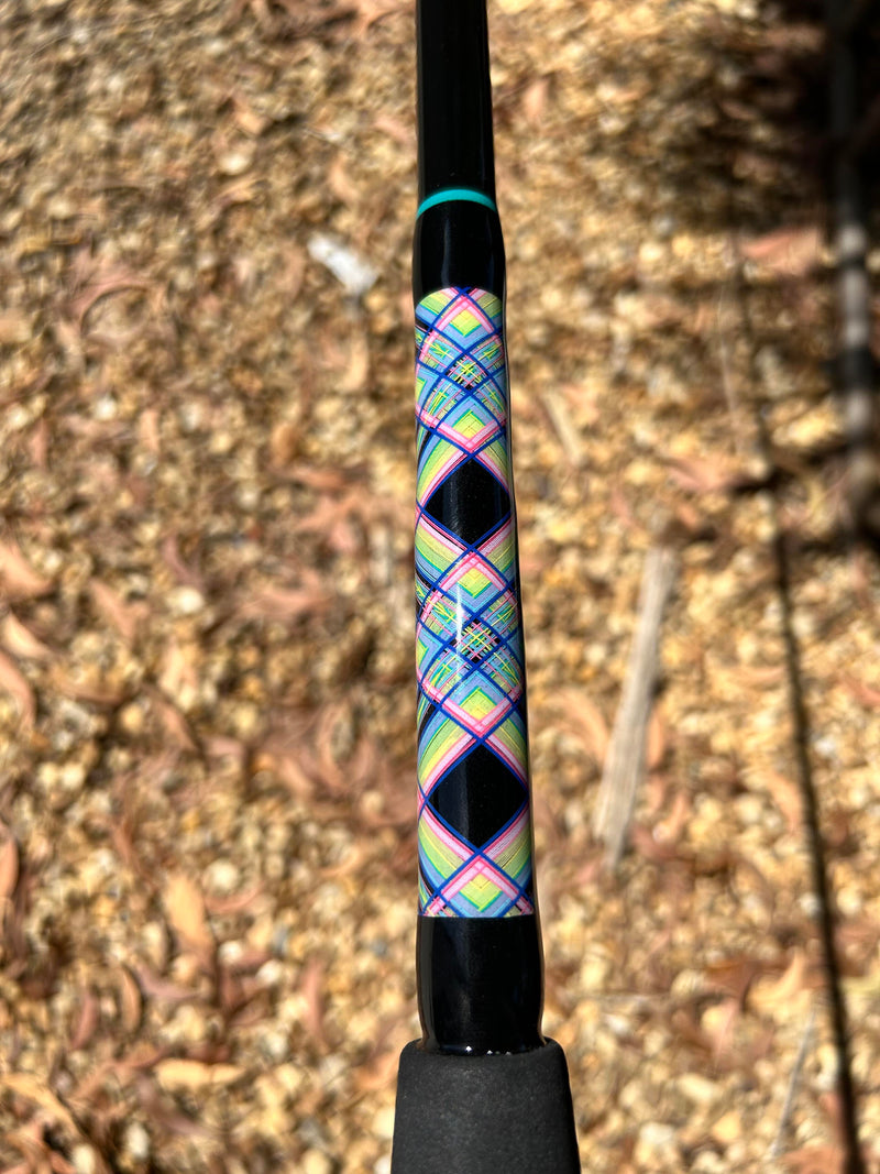 Load image into Gallery viewer, Built like our Fin #21, this spinning rod comes with Fuji alconite guides, EVA foam grips, Fuji reel seat, and metal gimble. Diamond pattern butt wrap shown. Black blank. teal trims at top. Blue, light pink, pink, yellow, light yellow and green are the colors.  
